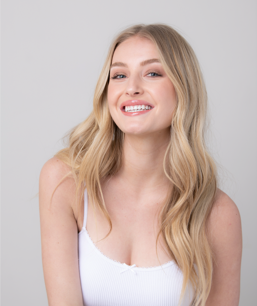 Beautiful blonde girl with a pretty smile wearing lip gloss